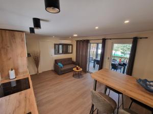 a living room with a couch and a table at Mobile home Sofija in Drage