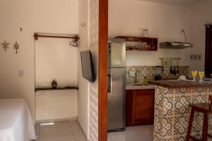 a kitchen with a stainless steel refrigerator and a counter at Swiss Garten Jeri in Jericoacoara