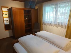 sypialnia z łóżkiem, oknem i szafką w obiekcie Haus Fischer w mieście Pettneu am Arlberg