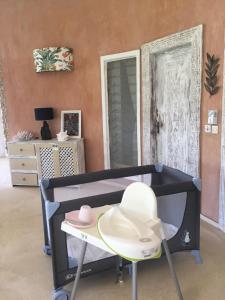 a baby crib with a hat on it in a room at Watamu Shell House in Watamu