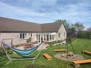 a blue hammock in the yard of a house at Scottish sea view near beach in Cockburnspath