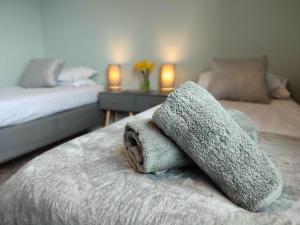 a bedroom with two beds with towels on the bed at Scottish sea view near beach in Cockburnspath