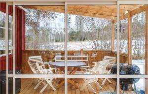 a screened in porch with a table and chairs at Lovely Home In Erikslund With Kitchen in Erikslund