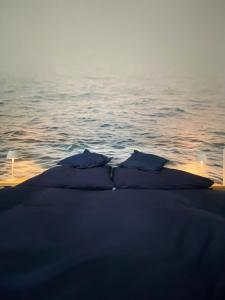 a group of pillows on a boat in the water at Ostseewelle, Parkplatz in Kiel