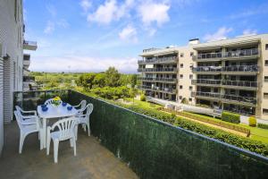 a balcony with a table and chairs and a building at JOEL 2 Planetcostadorada ONLY FAMILIES in Salou