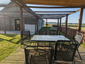 a patio with a table and chairs on a deck at Cottage with Panoramic Views in Kirk of Shotts