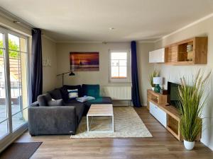 a living room with a couch and a table at Sonnendeck 3 in Zingst