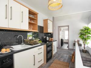 a kitchen with white cabinets and a sink at Upper Deck in Saint Erth