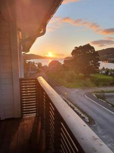 a view of the sunset from a balcony of a house at Nydelig leilighet- Solrik/2 balkonger in Seim