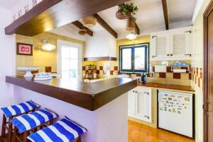 a kitchen with a counter and blue and white appliances at Villa Bini Roca in Cap d'en Font