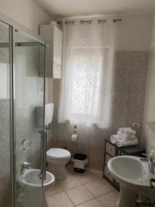 a bathroom with a toilet and a sink and a shower at La Rosa del Garda in Peschiera del Garda