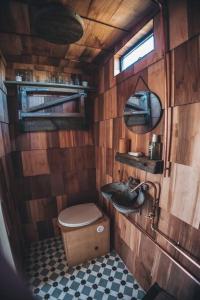 a small bathroom with a toilet and a sink at 'Cinnabar Nest' Remote Off-Grid Eco Cabin in Sedgefield