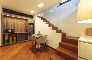 a staircase in a home with wooden floors and a table at Hi room vicolo del vò in Trento