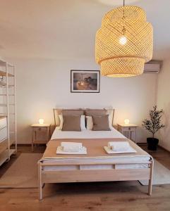 a bedroom with a large bed and a chandelier at Guesthouse Tamara in Lovište