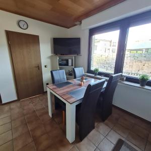 a dining room with a table and chairs at Ferienwohnung W.Esel in Wesel +9 photos