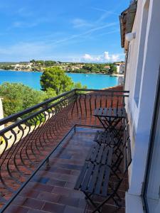 a balcony with benches and a view of the water at Guesthouse Tamara in Lovište
