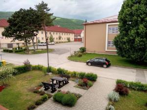 a car parked in a parking lot with a picnic table at Apartman Tomić in Korenica