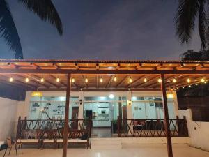 a patio with a deck with chairs and lights at Casa de playa Palmeras in Tumbes