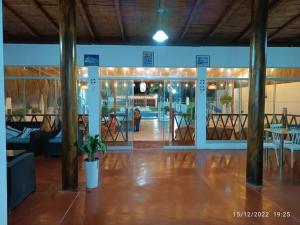 a lobby with a table and chairs in a building at Casa de playa Palmeras in Tumbes