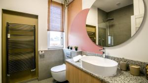 a bathroom with a sink and a mirror at City Center Terrace apartment with AC by Kovee in Bratislava