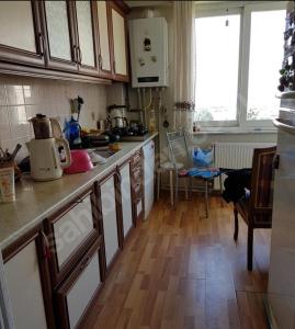 a kitchen with wooden floors and a counter top at Bostanci cozy excellent location flat in Istanbul