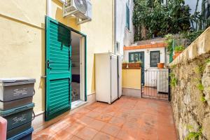 an open door to a kitchen with a refrigerator at Stella Marina in Scilla