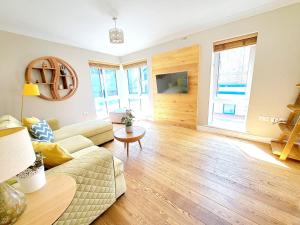 a living room with a couch and a table at Tottenham Spur Hideaway in London