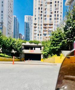 a parking lot in a city with tall buildings at Full 2 bedroom apartment in luxury complex in Esenyurt