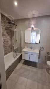 a bathroom with a tub and a sink and a shower at Palazzo del Prelato in Mdina