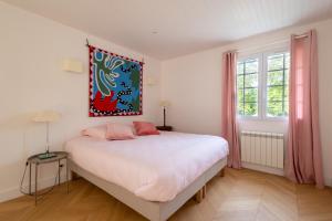 une chambre avec un lit et un tableau au mur dans l'établissement La Métairie - Largilière, à Orx 42 autres photos