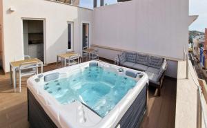 a hot tub on the balcony of a building at BeB Altomare in Lampedusa