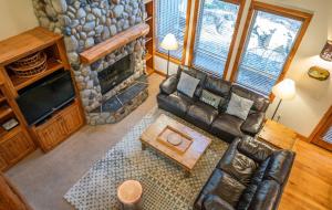 an overhead view of a living room with a stone fireplace at Aquila Lodge - Unit 5 in Sunriver