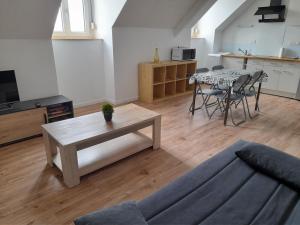 a living room with a couch and a table at Idéalement situé pour visiter la région Pordic-Tréméloir in Pordic