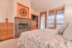 a bedroom with a bed and a fireplace at Aquila Lodge - Unit 5 in Sunriver
