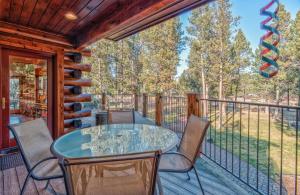 a patio with a glass table and chairs on a deck at Crane - Unit 6 in Bend