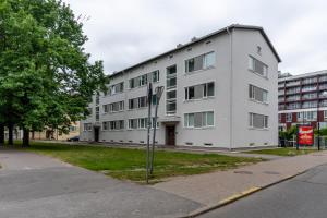 a large white building on the side of a street at Studio in the heart of Pärnu, free parking! in Pärnu