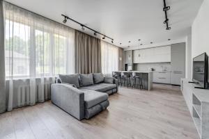 a living room with a couch and a kitchen at KALVARI APARTMENTs in Vilnius