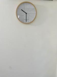 a clock hanging on a white wall at FABULEUX STUDIO Centre ville Fort De France Martinique CAPITALE in Fort-de-France