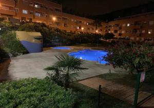 a view of a swimming pool at night at Apto. Jardín de Santa Bárbara in Blanes