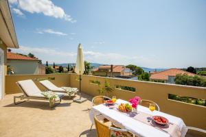 a patio with a table and chairs on a balcony at Villa Marica, Premium residence, Krk in Krk