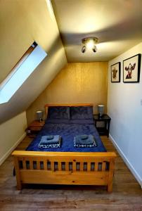 a bedroom with a bed in a attic at Cozy Loft In The Heart Of Kirkwall in Orkney