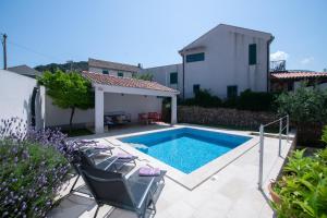 a swimming pool in the backyard of a house at Villa Mediterana in Vis