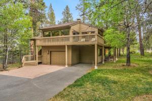 a large house with a balcony and a garage at Tan Oak - Unit 37 in Sunriver