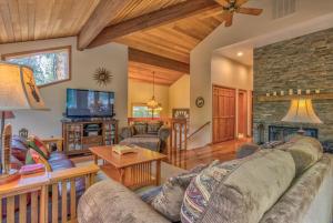 a living room with a couch and a fireplace at Tan Oak - Unit 37 in Sunriver