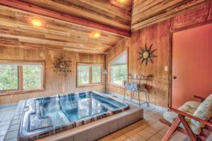 a jacuzzi tub in a room with wooden walls at Tan Oak - Unit 37 in Sunriver