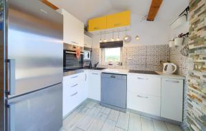 a kitchen with white cabinets and a refrigerator at Rooftop Krk in Krk