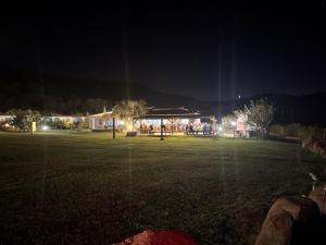 a park at night with a building with lights at Hotel Baia Cea in Bari Sardo