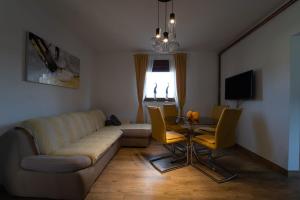 a living room with a couch and a table at House Malkoc in Saborsko