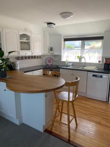 a kitchen with a table and a chair in it at Two bed flat with stunning views over Fistral Bay! in Newquay