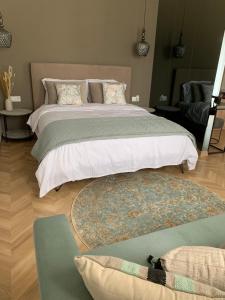 a bedroom with two large beds and a rug at Atelie home experience serres in Serres